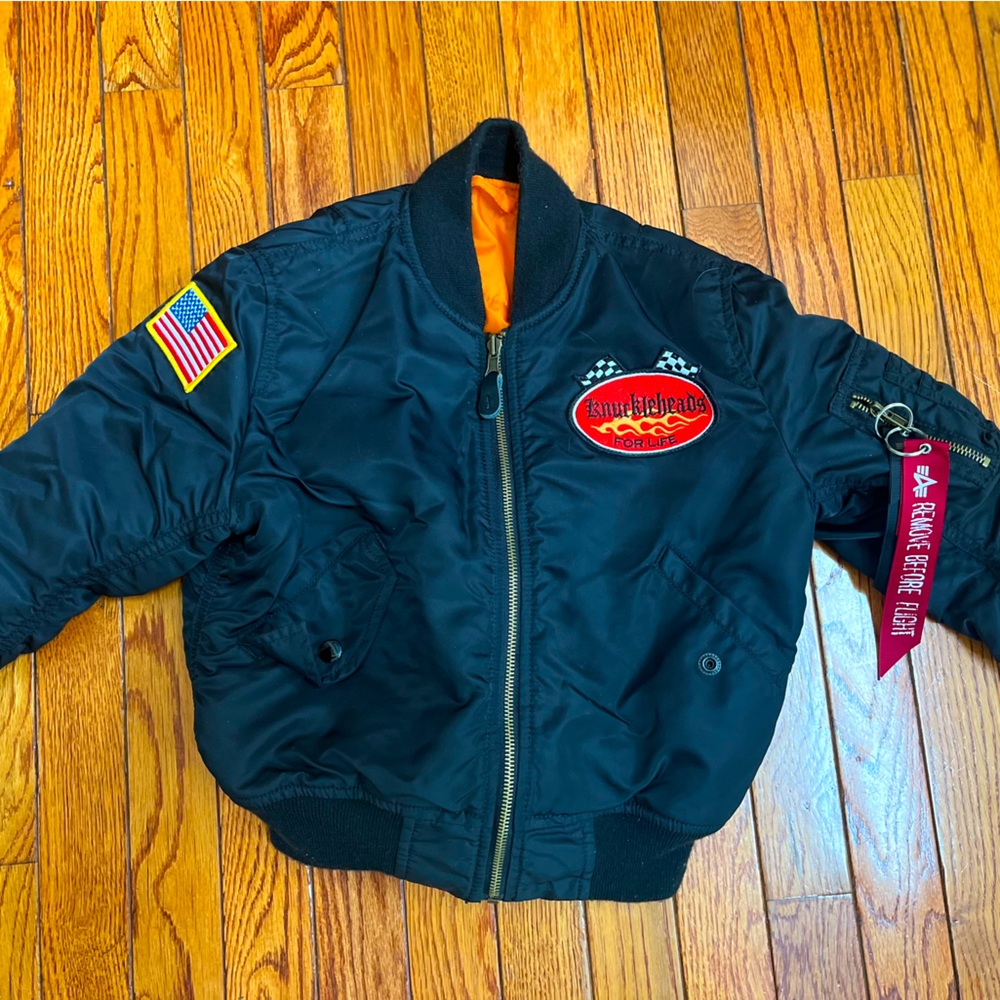 Alpha Industries kids MA-1 bomber jacket featuring Knuckleheads artwork.
